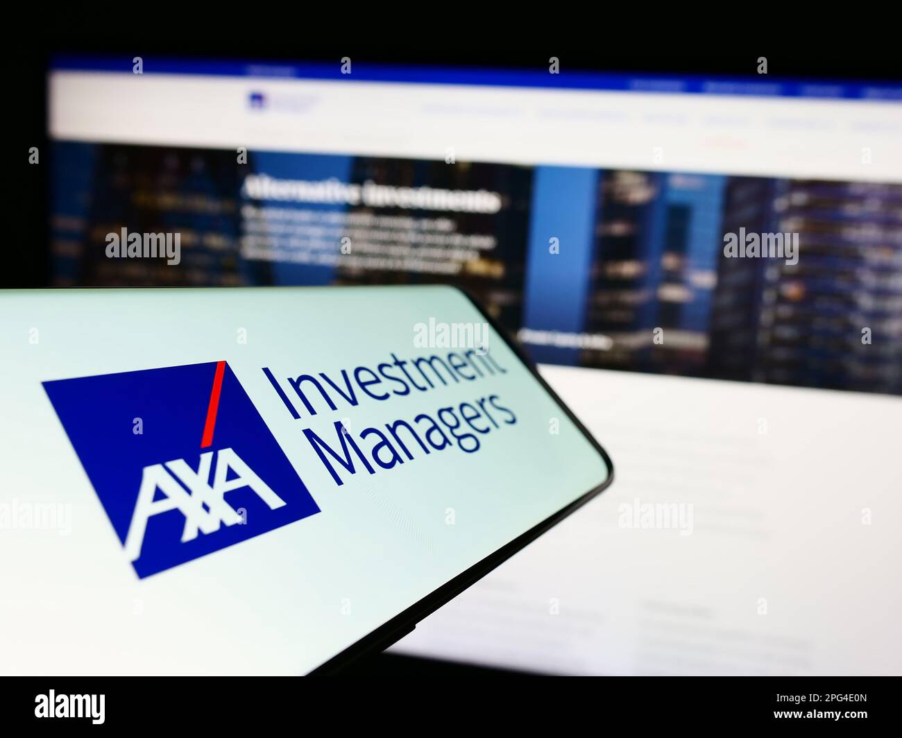 Cellphone with logo of investment company Axa Investment Managers on screen in front of business website. Focus on center-left of phone display. Stock Photo