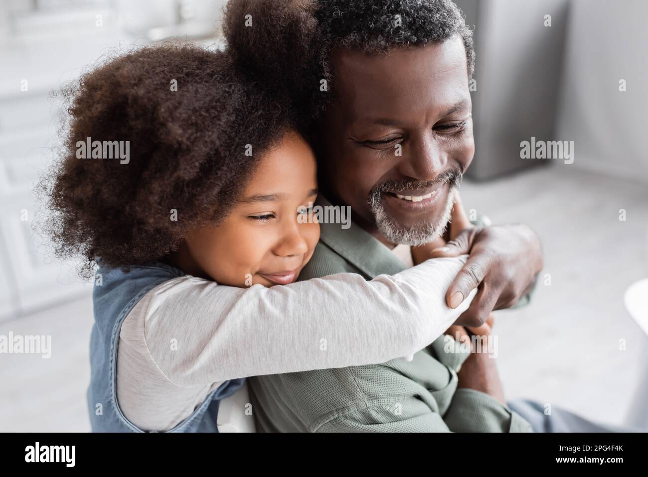 happy african american girl with curly hair hugging cheerful ...