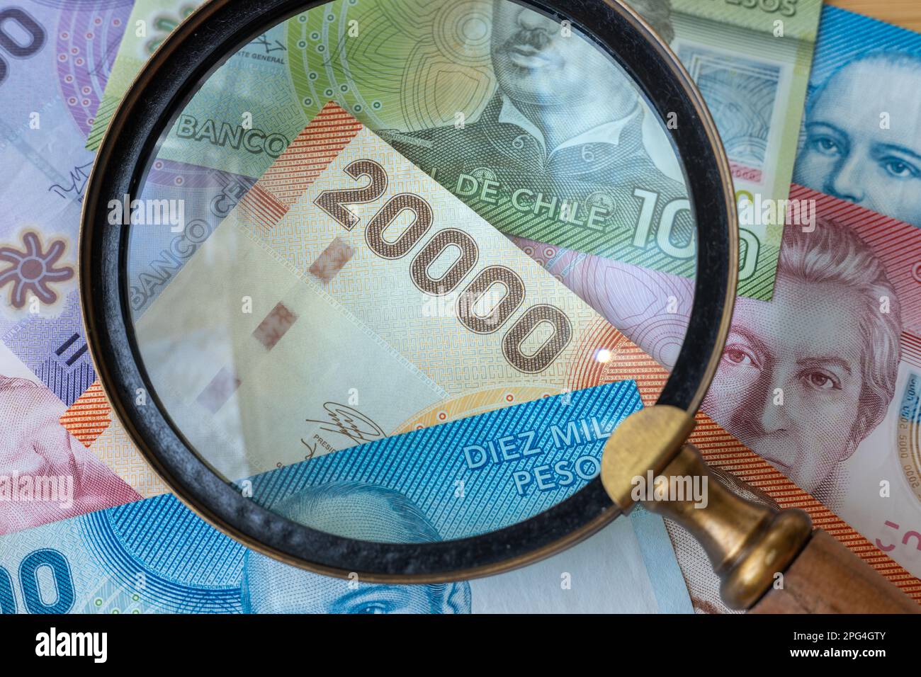 chile money seen through a magnifying glass, high denominations, financial and economic concept, close up Stock Photo