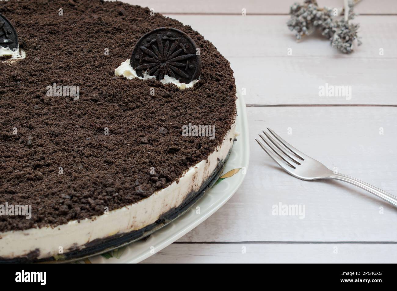 Cheesecake with chocolate chip cookie and a dessert fork Stock Photo