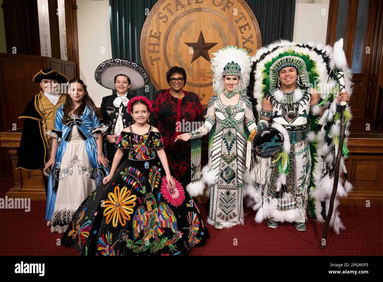 Texans from Laredo pose and parade through the Texas Capitol to promote