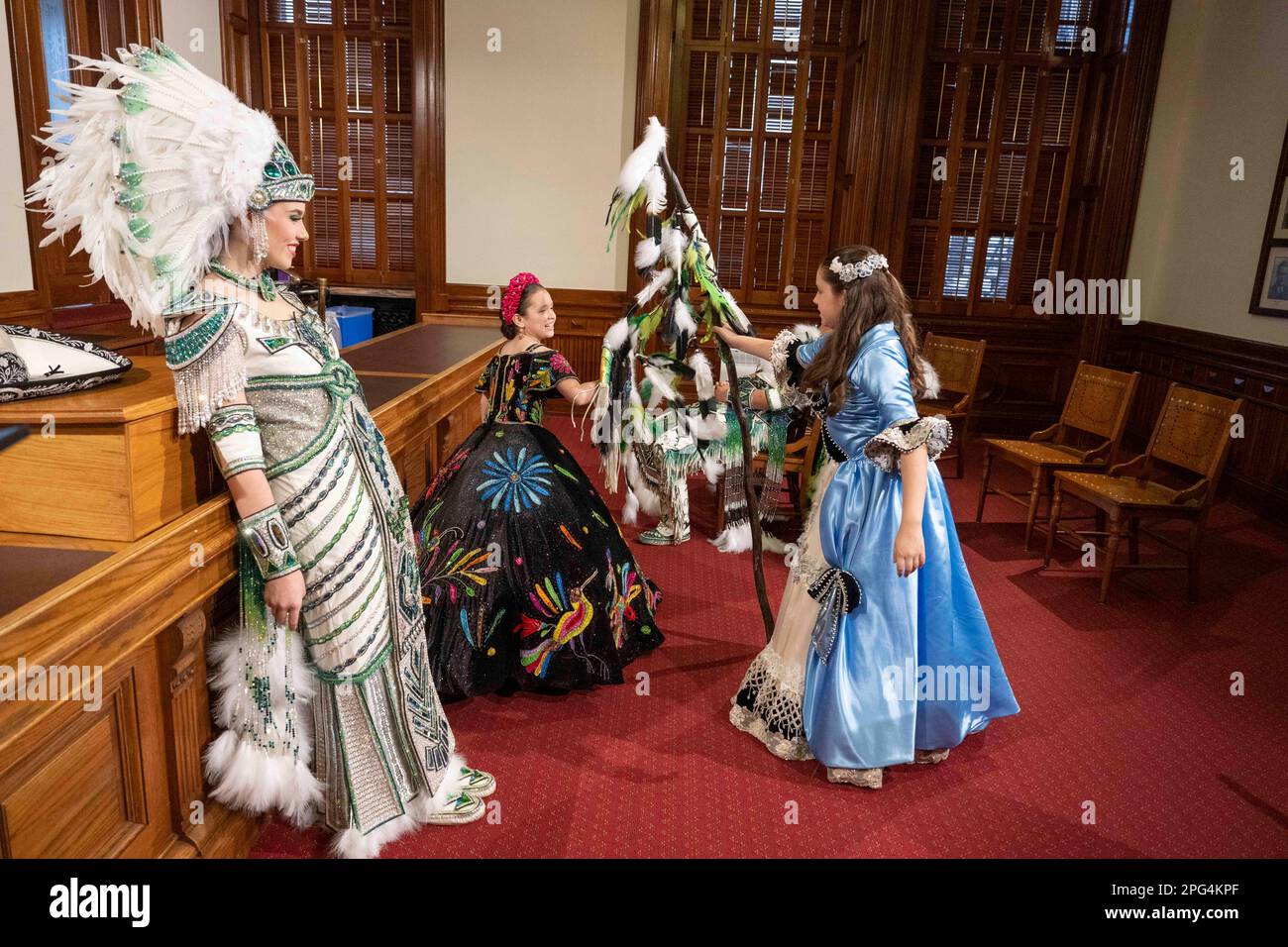 Texans from Laredo pose and parade through the Texas Capitol to promote