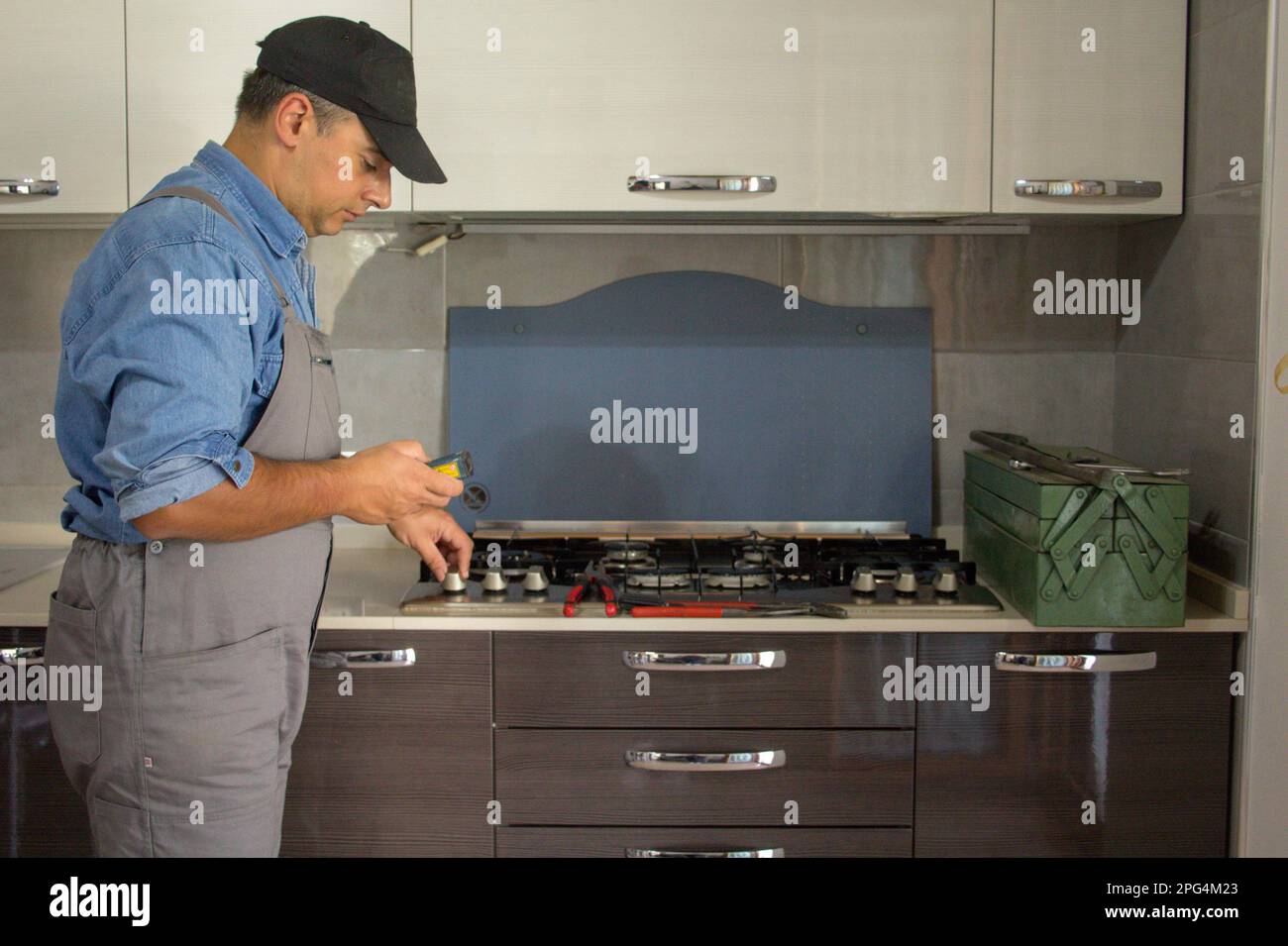 Image of a handyman technician who with a detector carries out checks