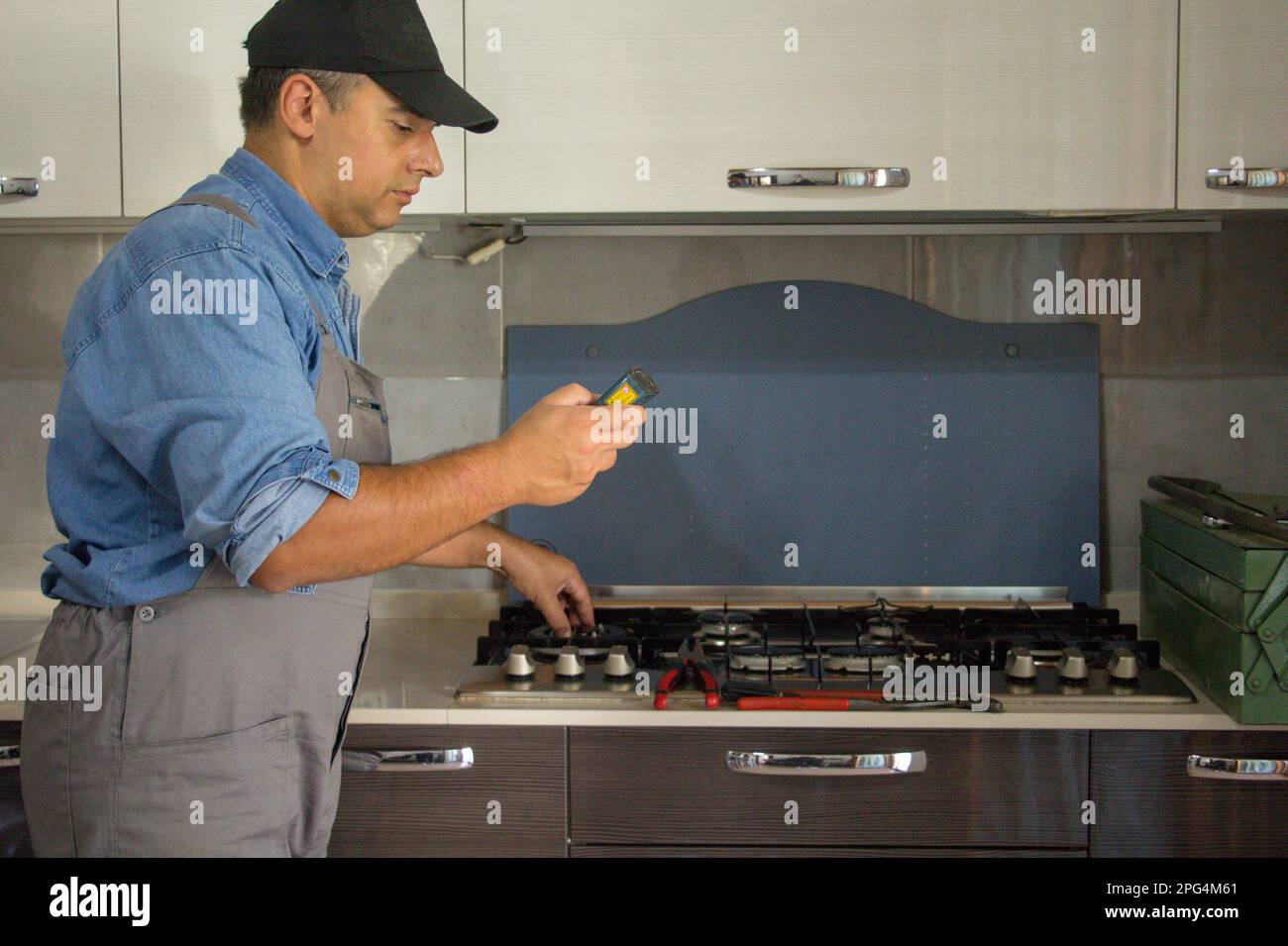 Image of a handyman technician who with a detector carries out checks