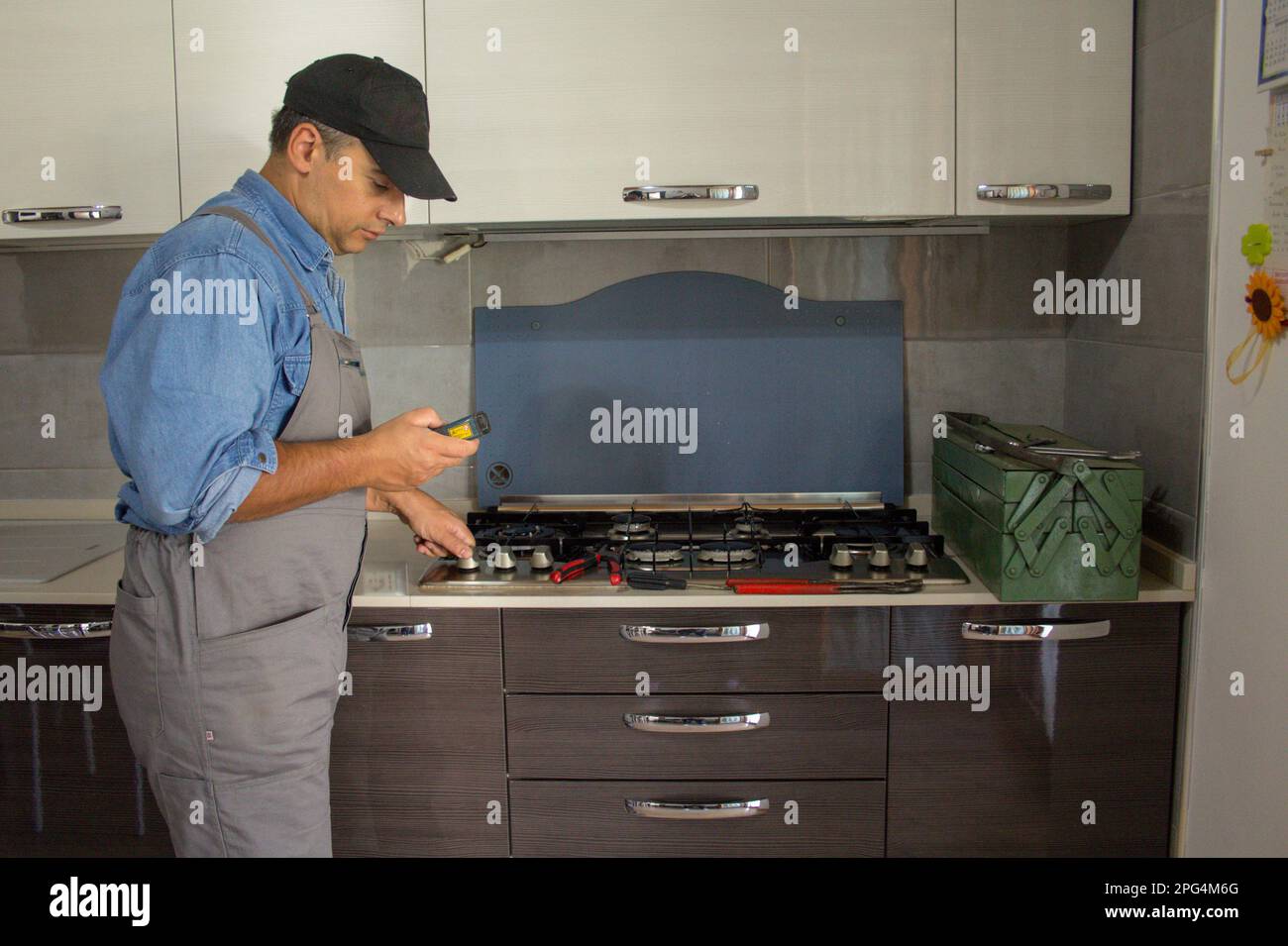 Image of a handyman technician who with a detector carries out checks