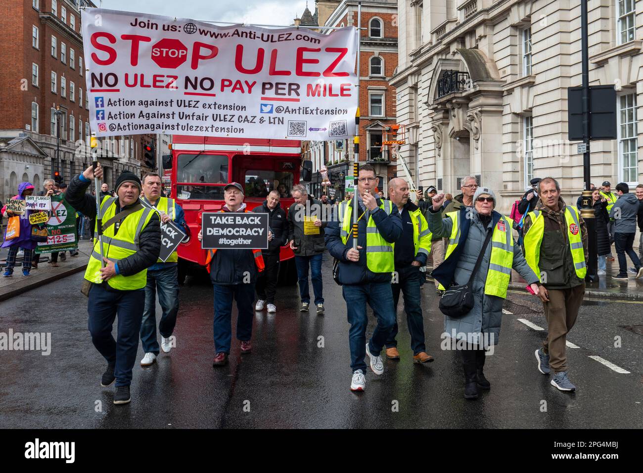 Protest against ULEZ zone expansion in London, UK. Protesters leading a vintage Routemaster bus Stock Photo