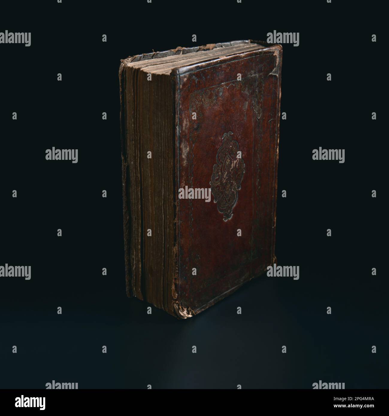 Leather bound book with gold embossing. Torah book standing in the dark