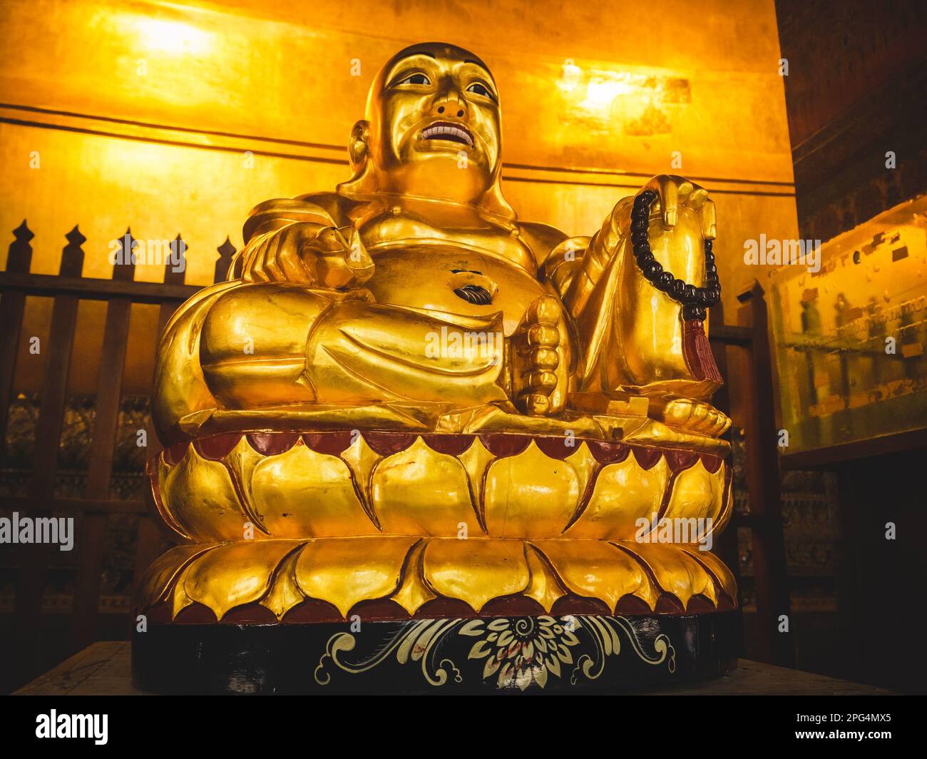 A close up view of a Golden Buddha statue standing in Wat Pho at ...