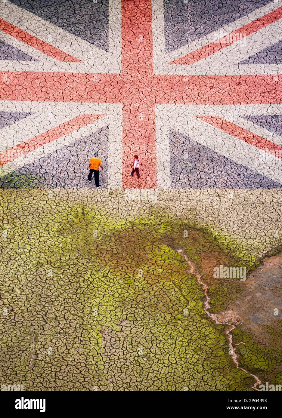 Man and young girl walking on cracked, dry lake bed. UK flag overlaid. Global warming, climate change, drought... UK concept. Stock Photo