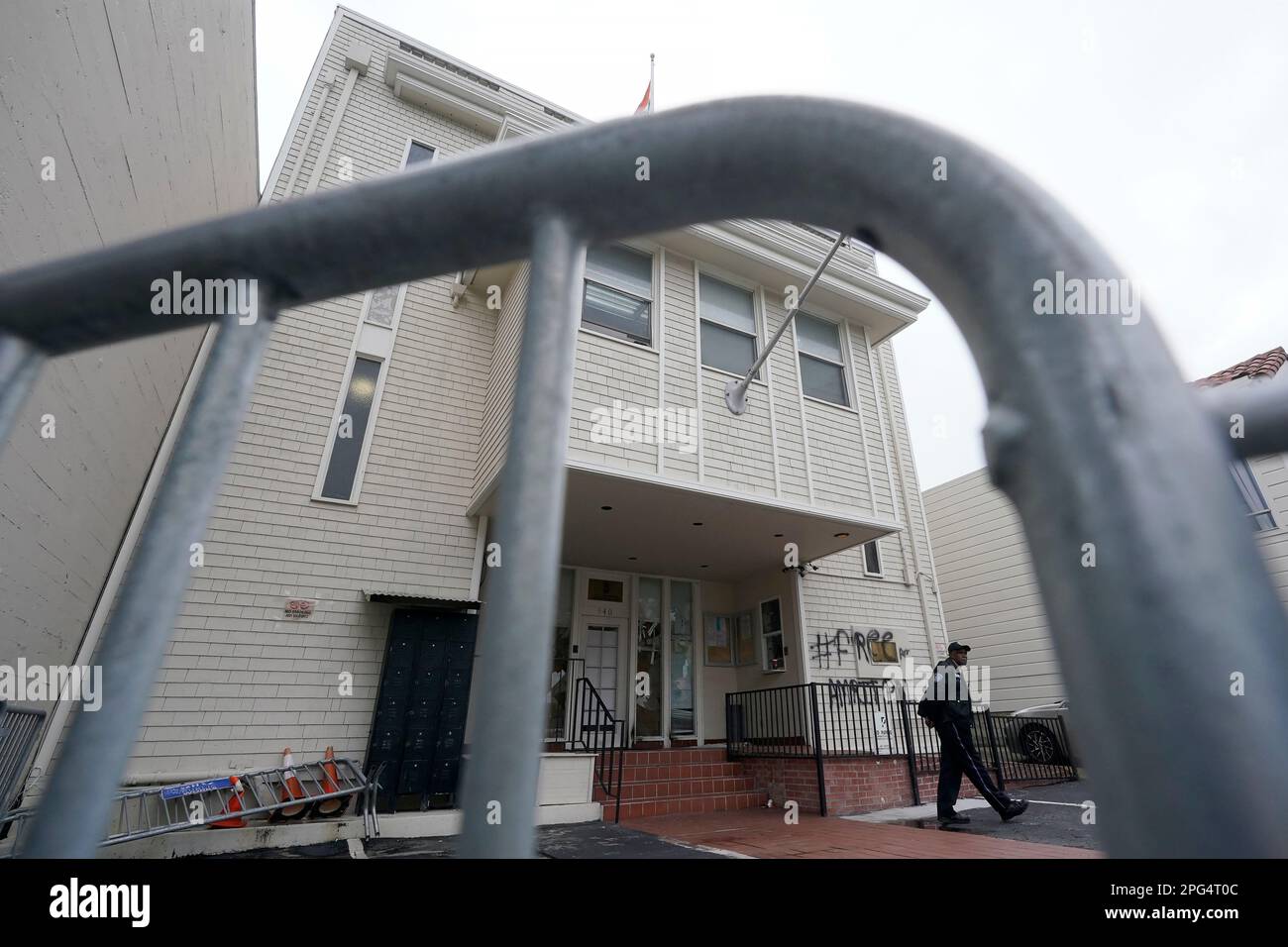 A security guard walks in front of the entrance to the consulate