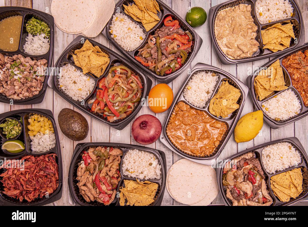 Set of food delivery containers filled with Mexican recipes with stews