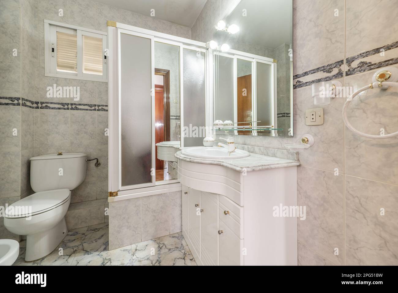 An oldfashioned bathroom with a white wooden with drawers, a