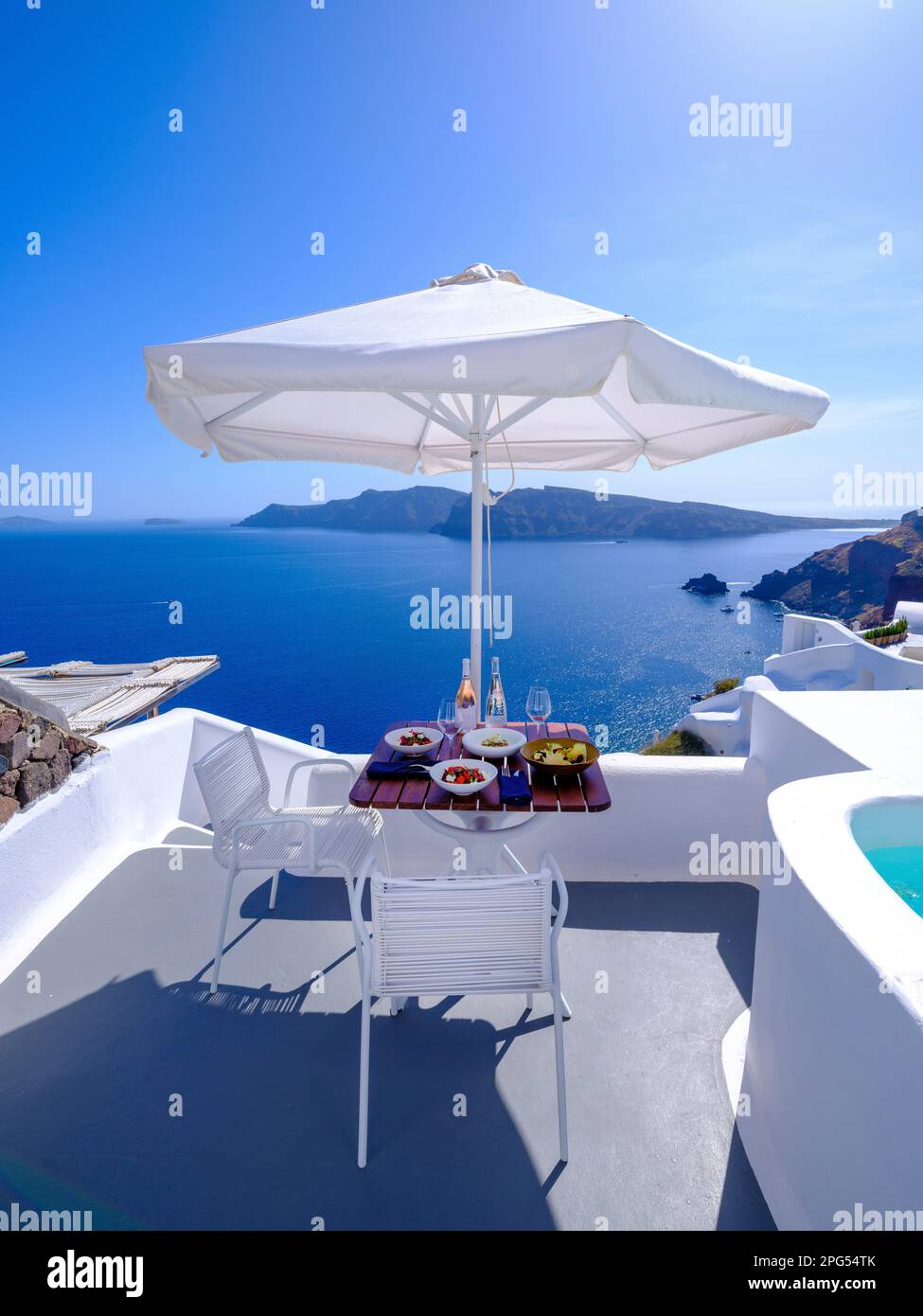 Lunch with a View, Caldera View from Katikies Hotel, Volcano Crater Santorini , Oia,Greece,Europe  Aegean Sea,Mediterranean Stock Photo