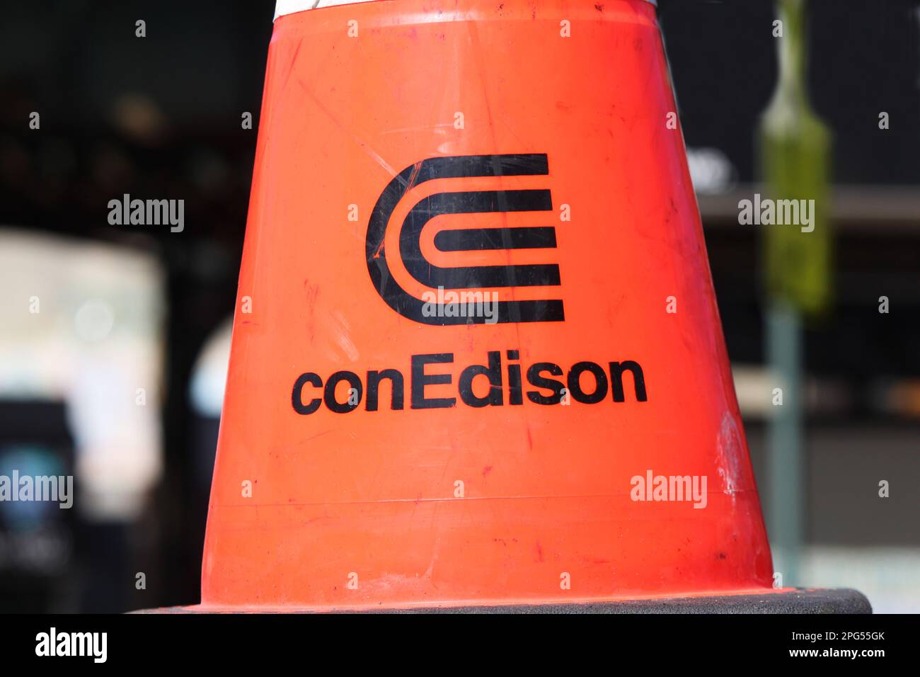 New York, NY - March 19, 2023: Orange construction cone with gas and electric utility provider ConEdison name, corporate logo close on city street Stock Photo