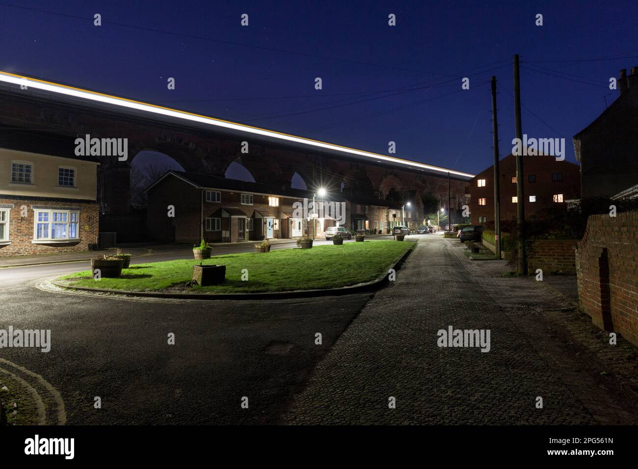 LNER train crossing Yarm viaduct, county Durham when diverted due to engineering work leaving light trails at dusk Stock Photo