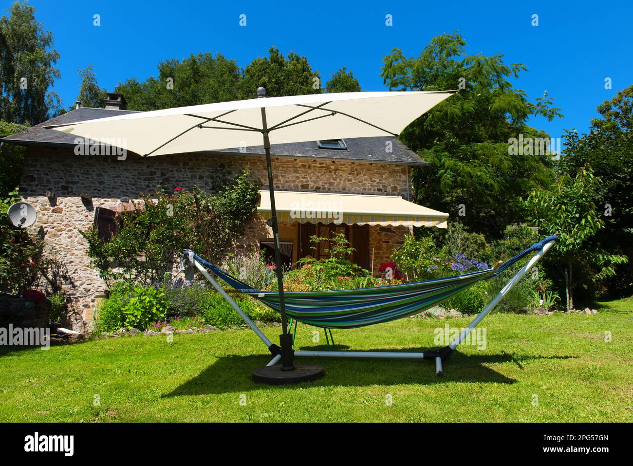 Hammock ready to relax in the sun in French garden Stock Photo Alamy