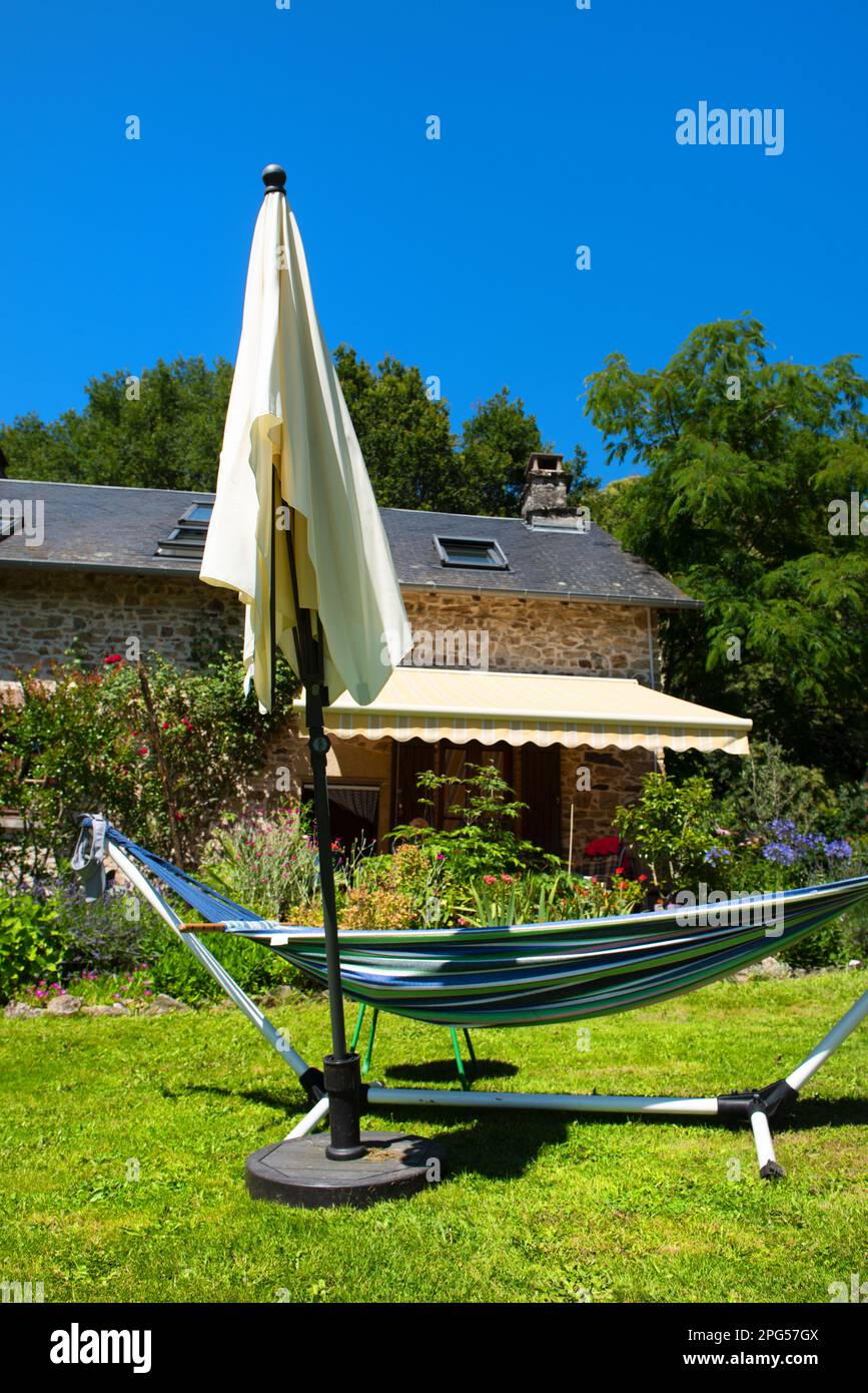 Hammock ready to relax in the sun in French garden Stock Photo Alamy