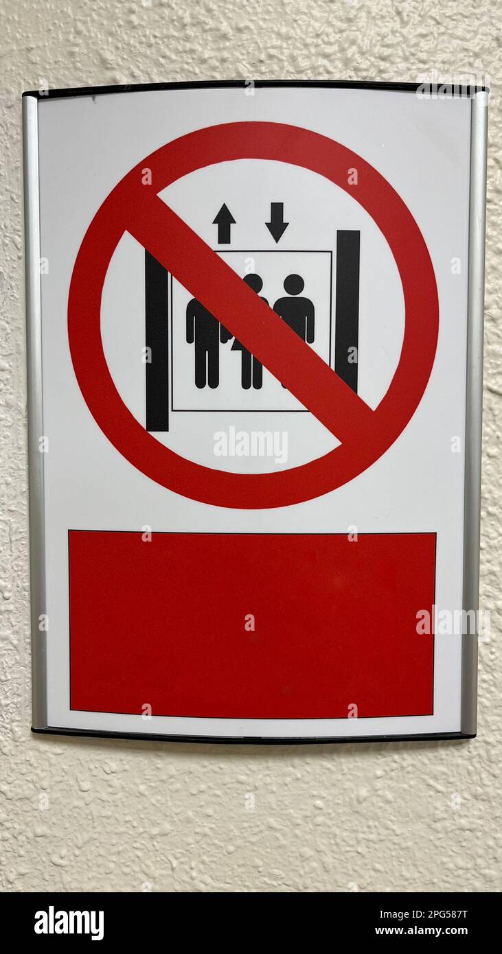 Warning sign: Do not use elevators during fire. Red prohibition sign at the top of the elevator on a white background Stock Photo