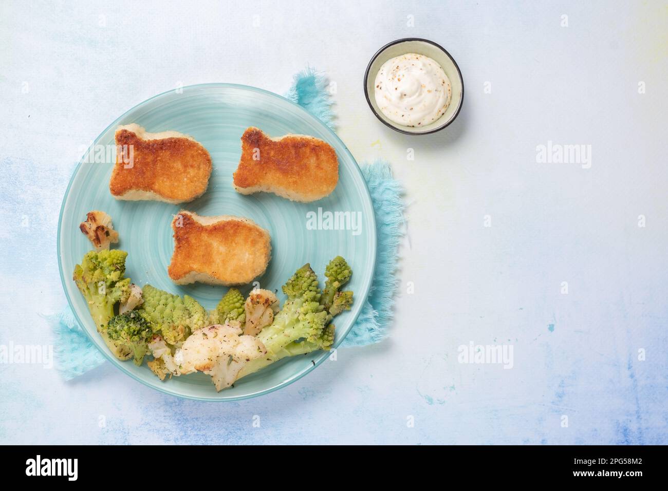 Kids food. Fish shaped nuggets with vegetable Stock Photo - Alamy