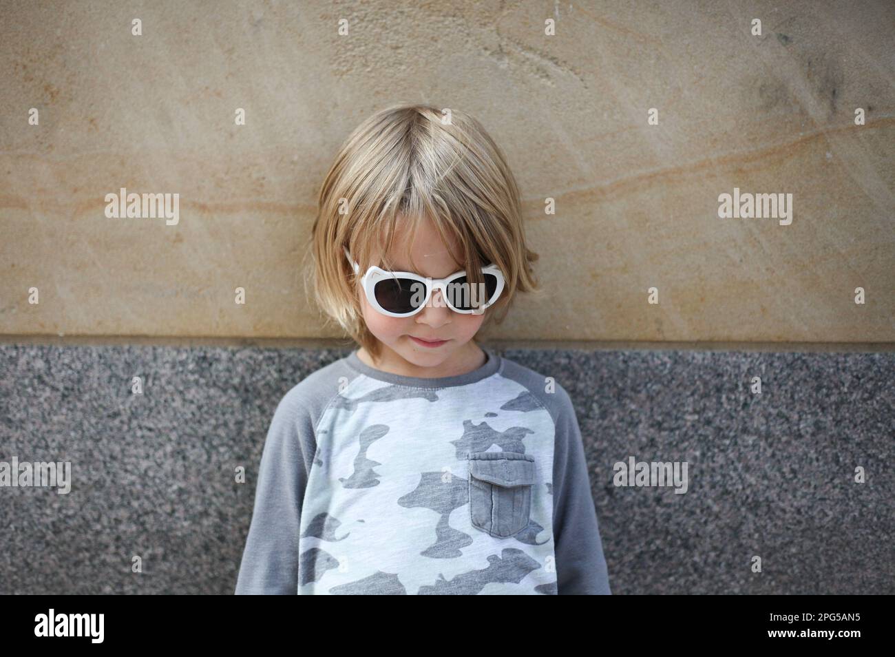 Young boy wearing cool sunglasses Stock Photo