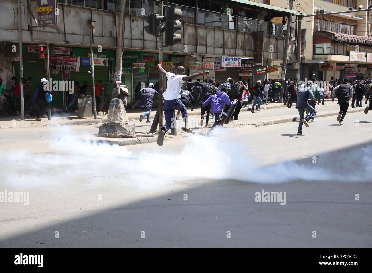 Nairobi, Kenya. 20th Mar, 2023. Protesters run for safety in downtown