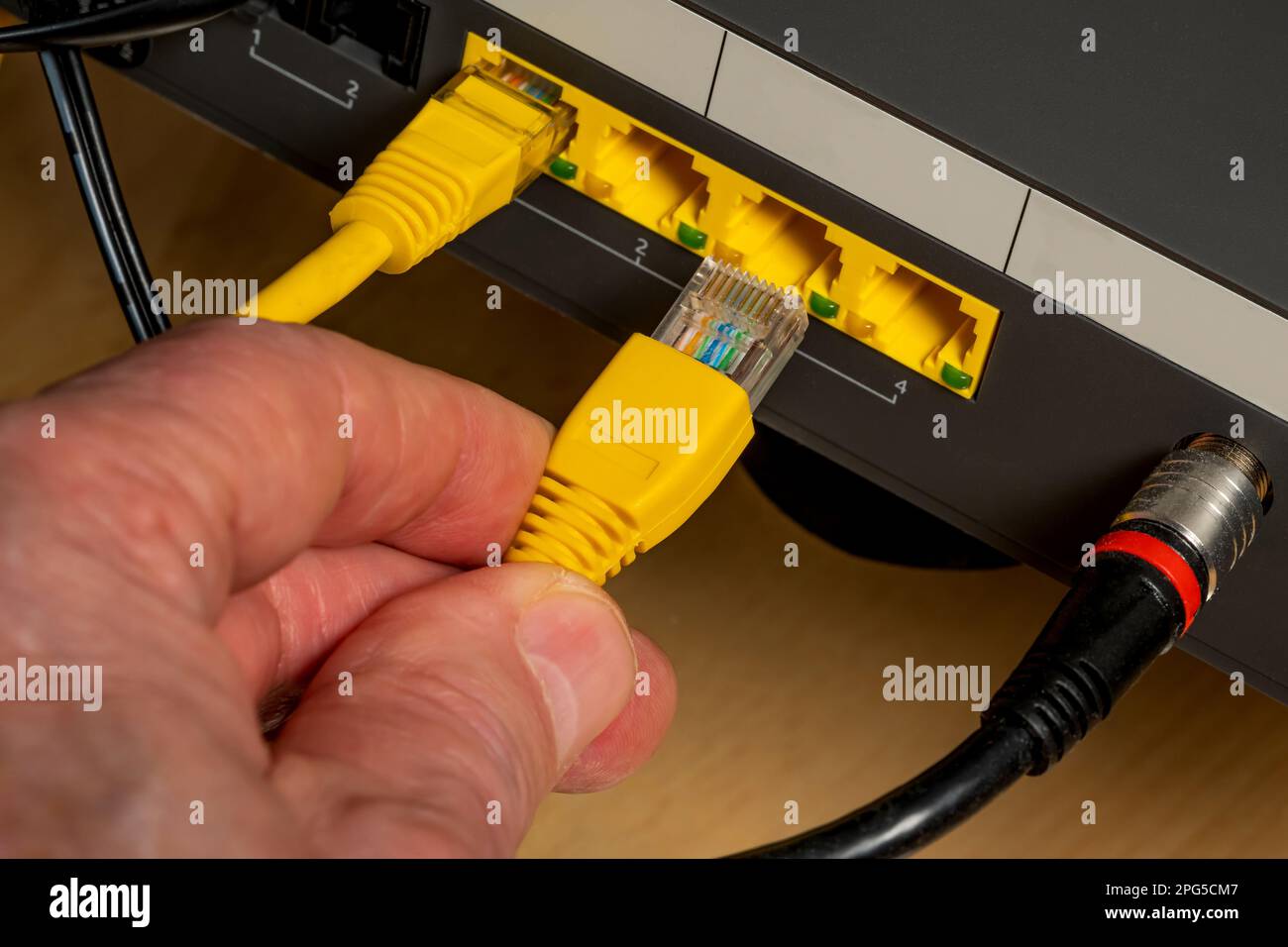 Connecting the device to the Internet using a cable. Close up. Stock Photo