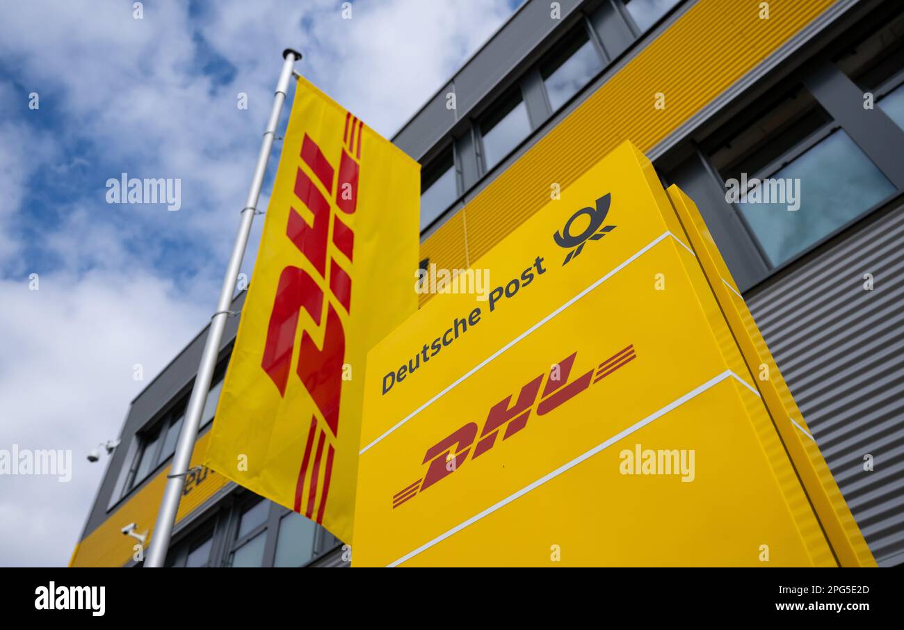 Aschheim, Germany. 20th Mar, 2023. A sign and a flag with the DHL logo stand at the DHL parcel
