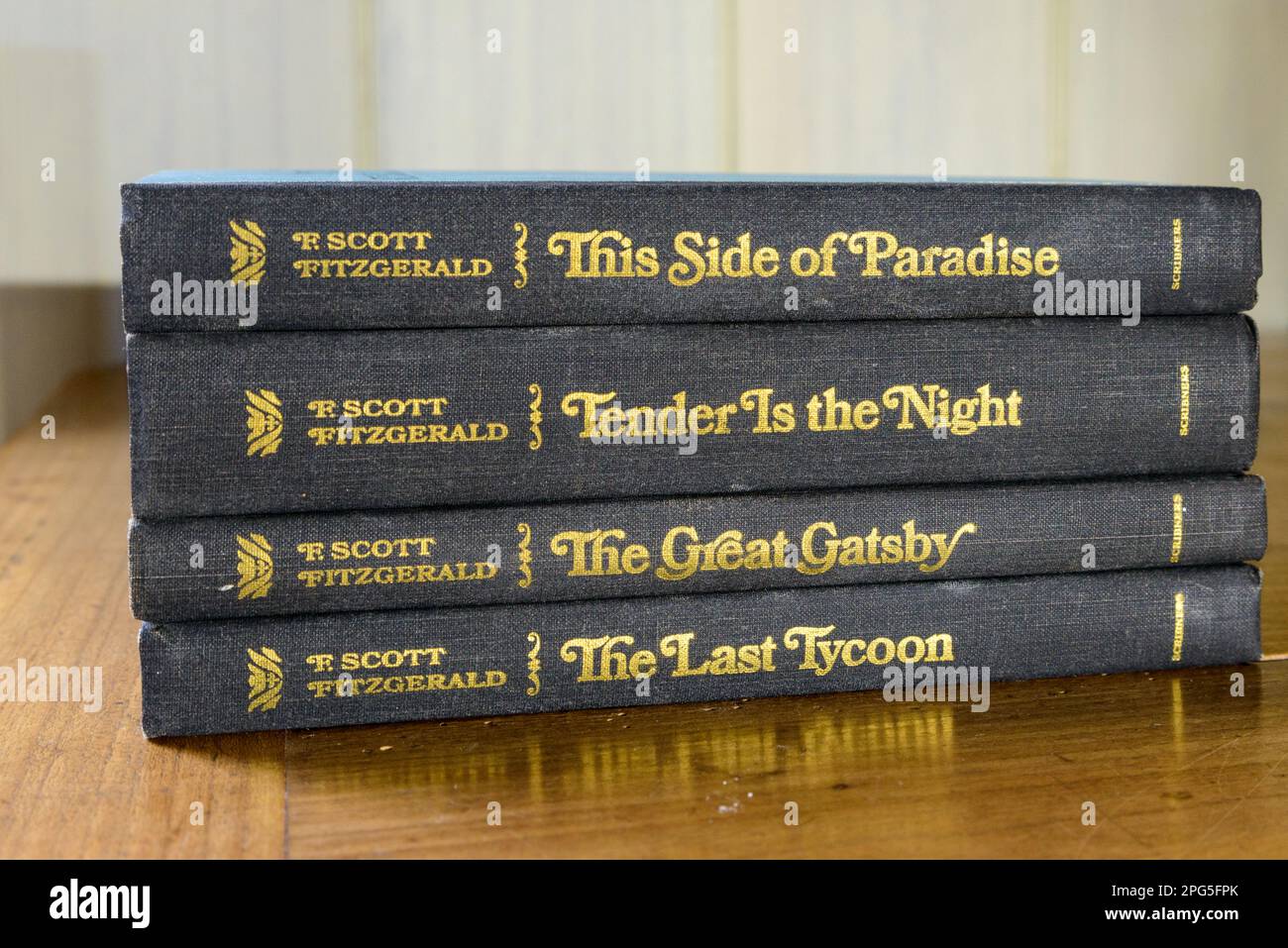 NEW ORLEANS, LA, USA - MARCH 19, 2023: Closeup of four F. Scott Fitzgerald books stacked sideways on a tabletop Stock Photo