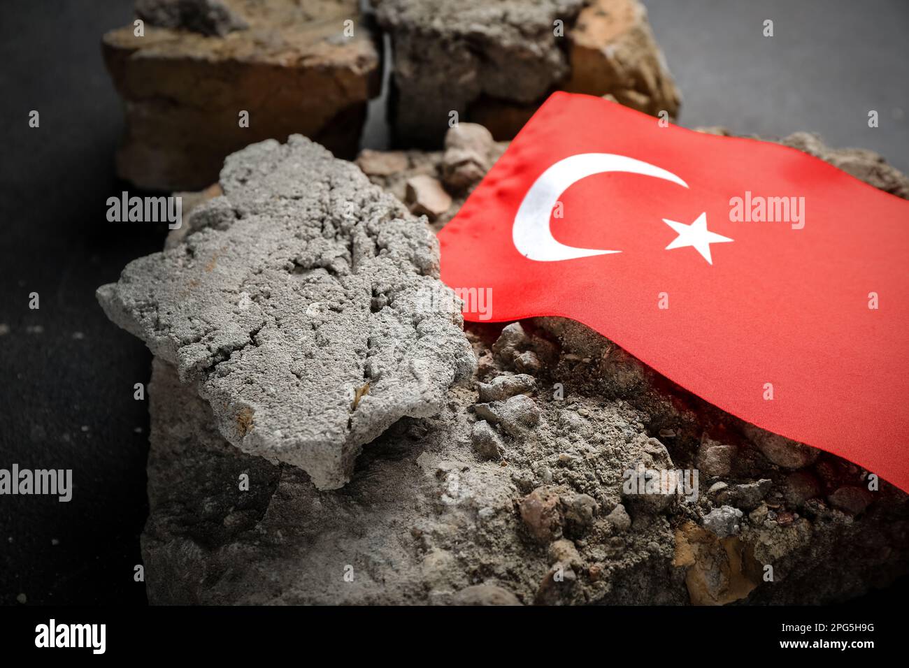 Stone debris with Turkish flag on dark background, closeup. Turkey ...