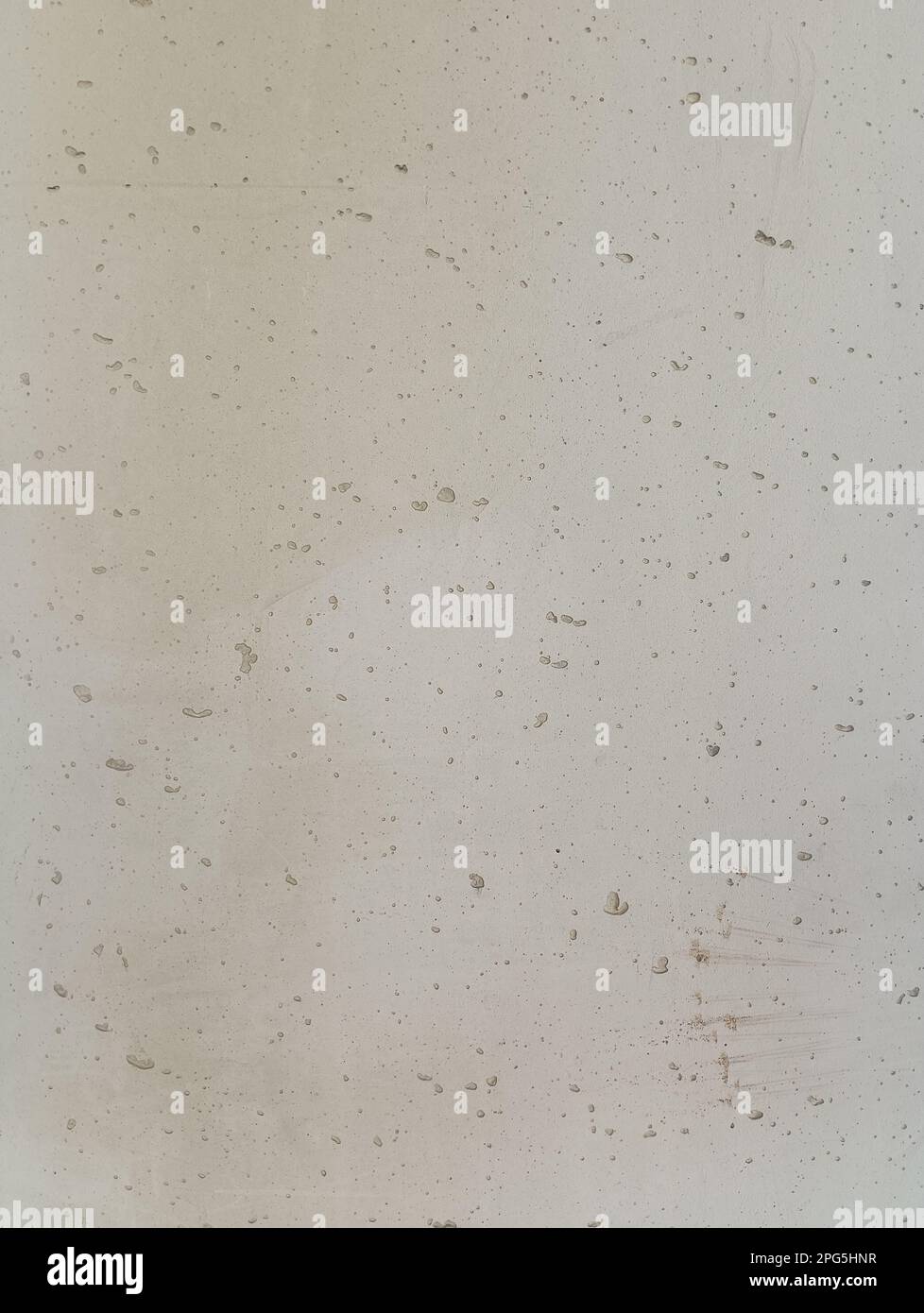 Concrete background of light gray uneven texture with gouges and dents ...