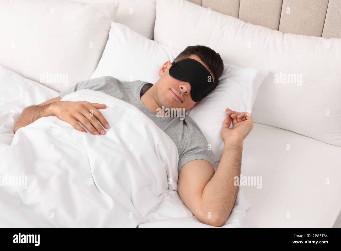 Man wearing sleeping mask in bed at home, above view Stock Photo Alamy