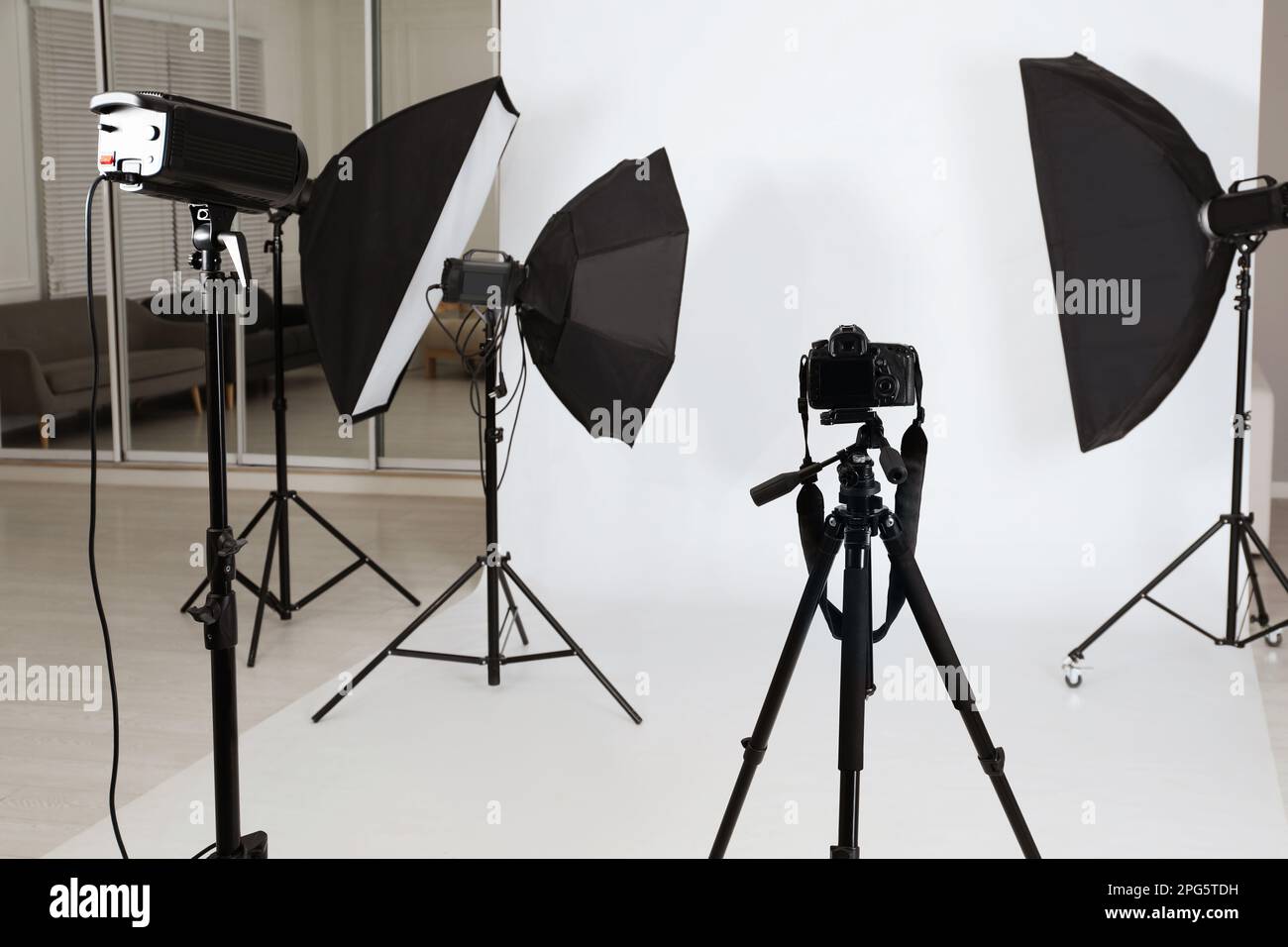 Empty photo studio with lighting equipment. Professional camera, lenses and  filters for photographer Stock Photo - Alamy