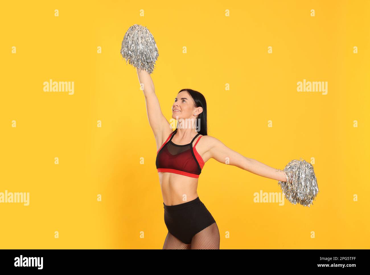 Smiling cheerleader girl posing with pom poms. Isolated on white Stock  Photo - Alamy