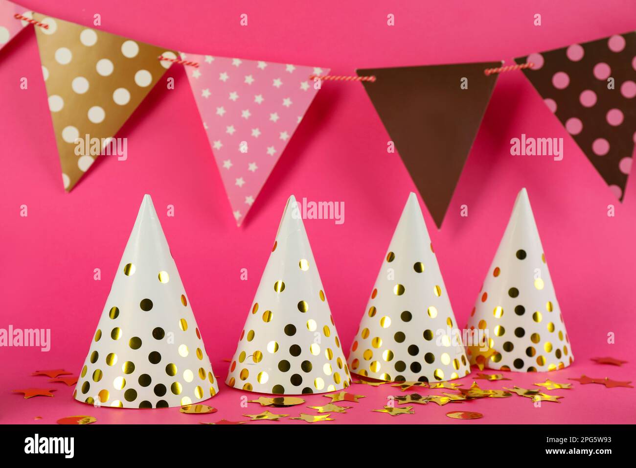 Colorful party hats and other festive items on pink background Stock ...