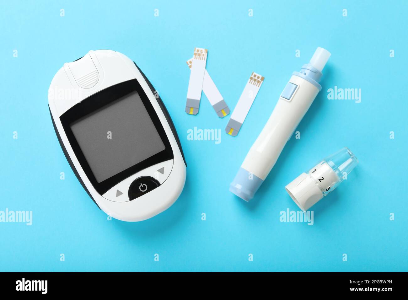 Digital lancet pen and test strips on light blue background