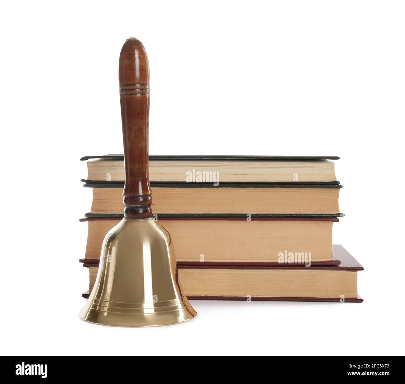 Golden school bell with wooden handle and stack of books on white background Stock Photo