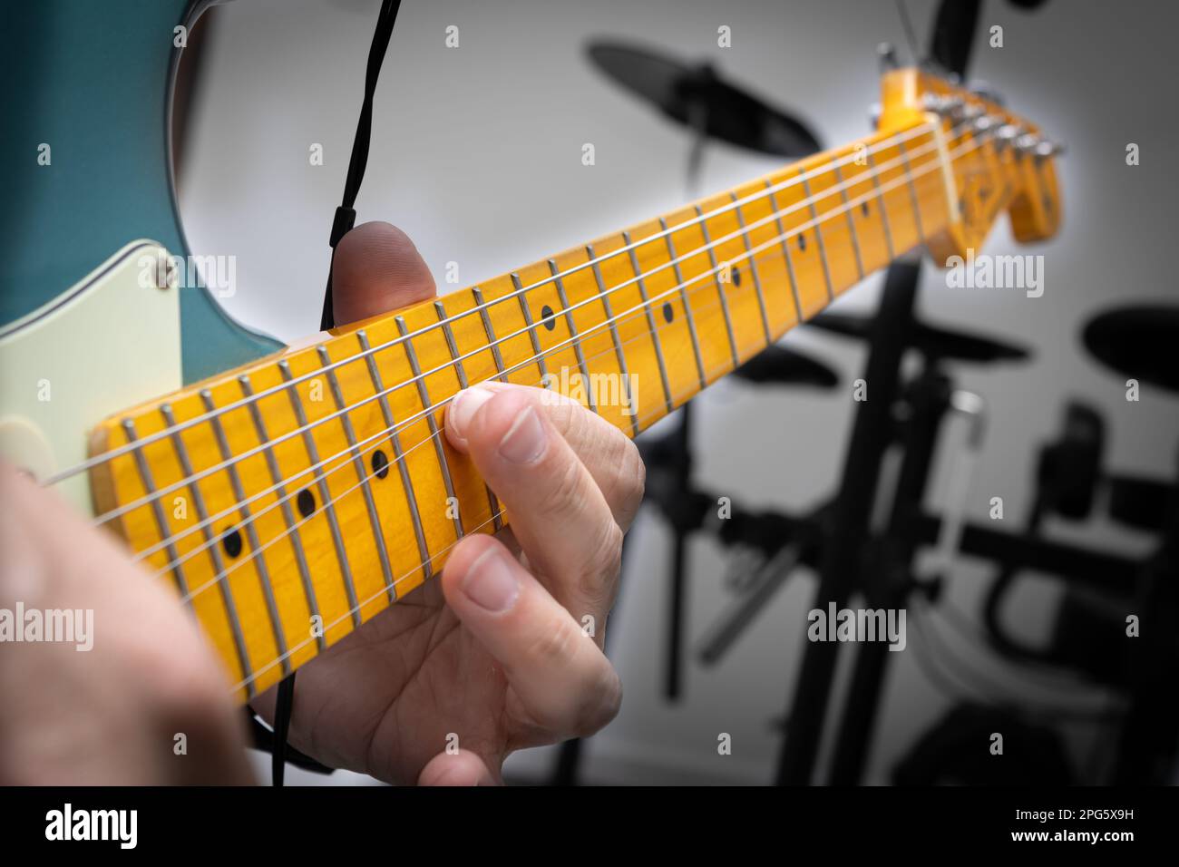 Blue electric guitar in musical solo, showing in detail the string