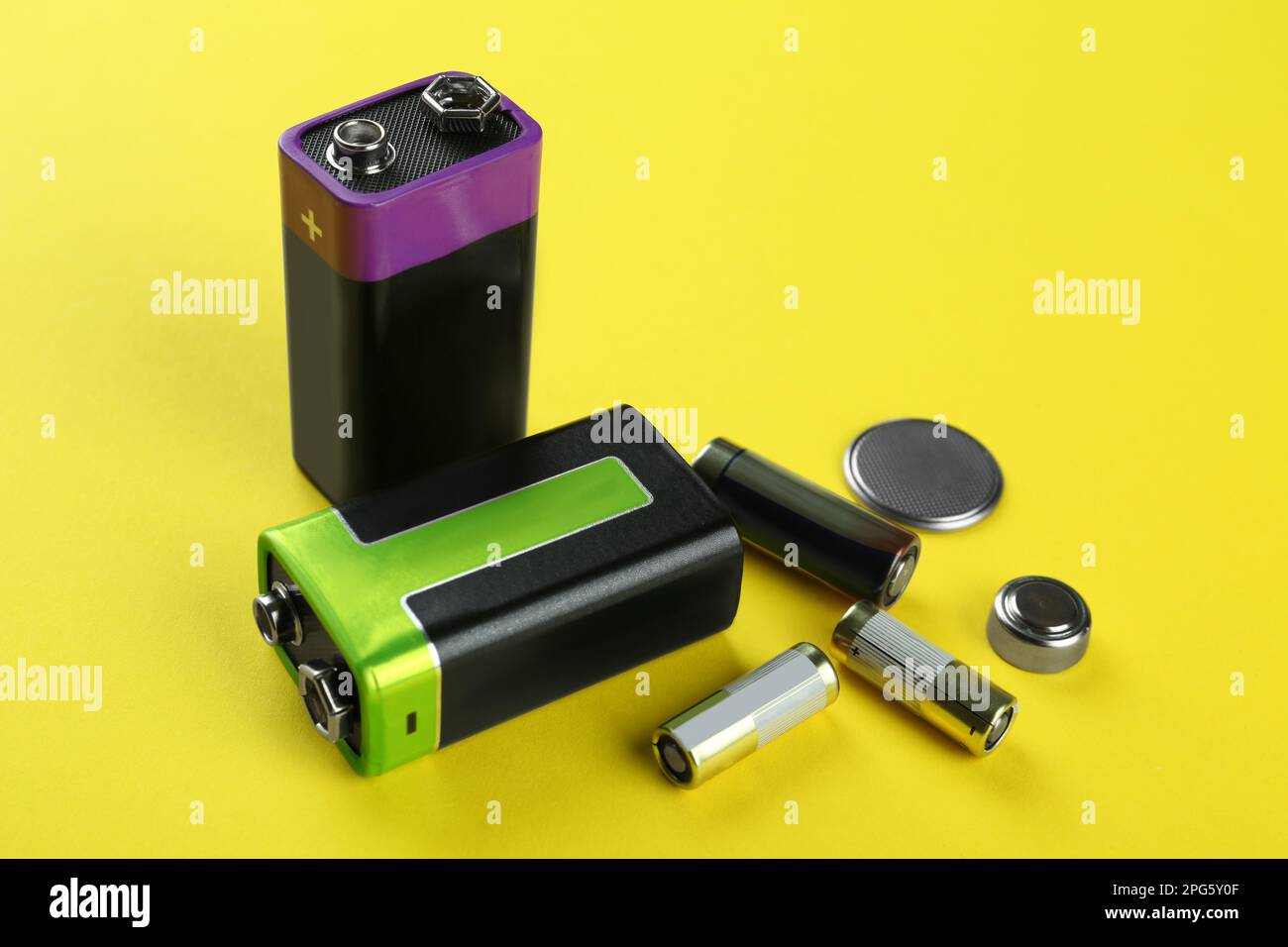 Different types of batteries on yellow background Stock Photo Alamy