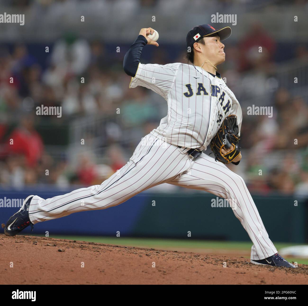 Yoshinobu Yamamoto of Japan throws a ball during the World Baseball