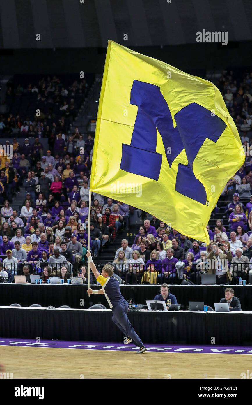 Baton Rouge, LA, USA. 19th Mar, 2023. A Michigan Cheerleader leads the team out of the tunnel with the Michigan flag during second round action of the NCAA Women's March Madness Tournament between the Michigan Wolverines and the LSU Tigers at the Pete Maravich Assembly Center in Baton Rouge, LA. Jonathan Mailhes/CSM/Alamy Live News Stock Photo