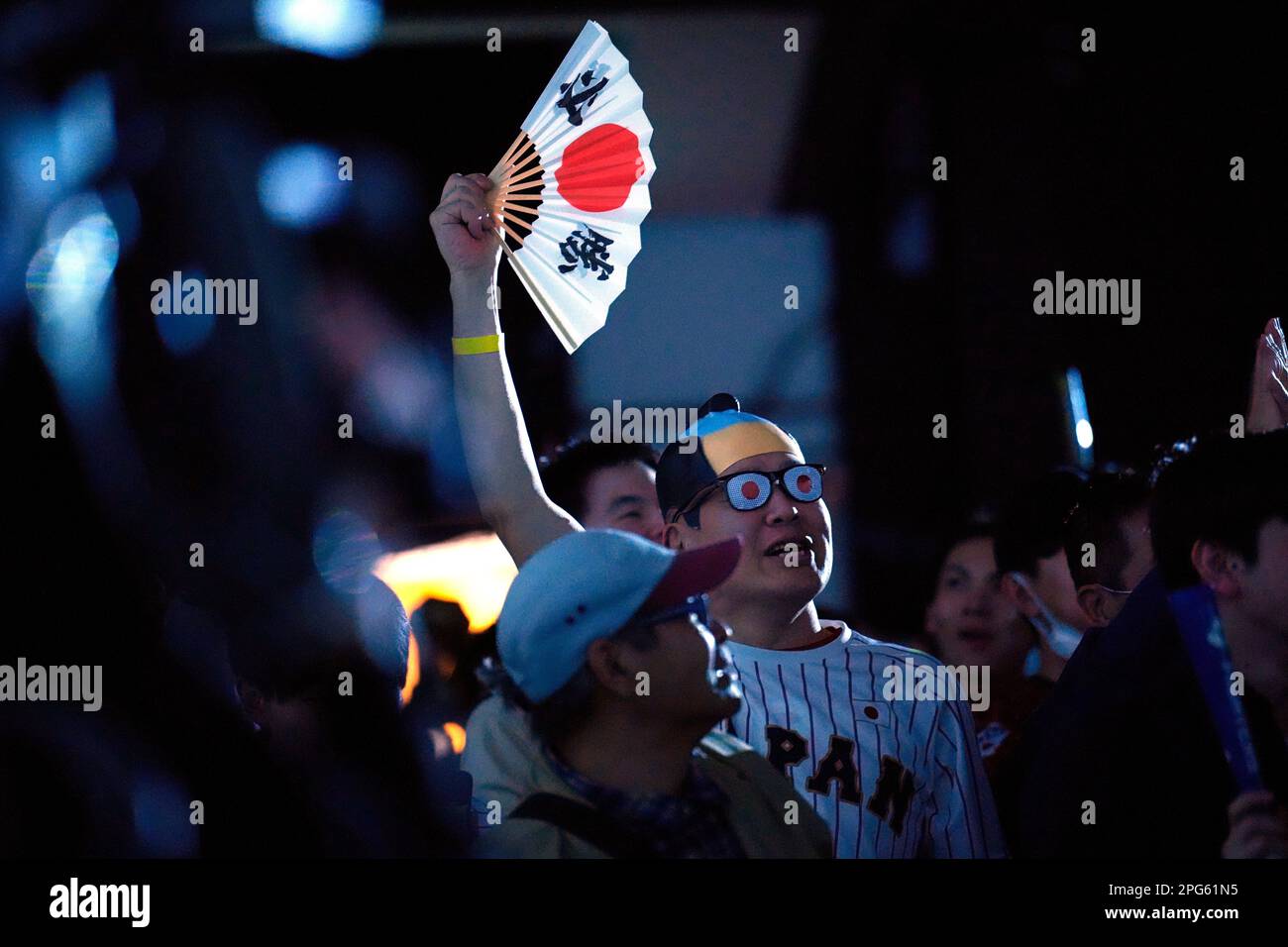 Japan fans react after Japans Masataka Yoshida hit a home rum in the 7th inning as they watch on a live stream of a World Baseball Classic (WBC) semifinal between Japan and