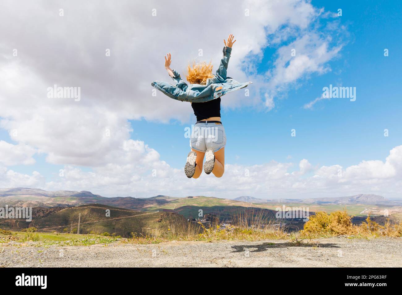 woman jumping joy hilltop. High resolution photo Stock Photo