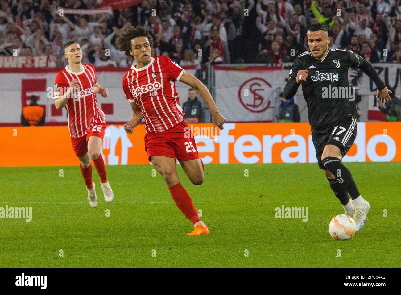 Kiliann SILDILLIA (SC Freiburg) left, tackles Filip KOSTIC (Juventus Turin) Stock Photo