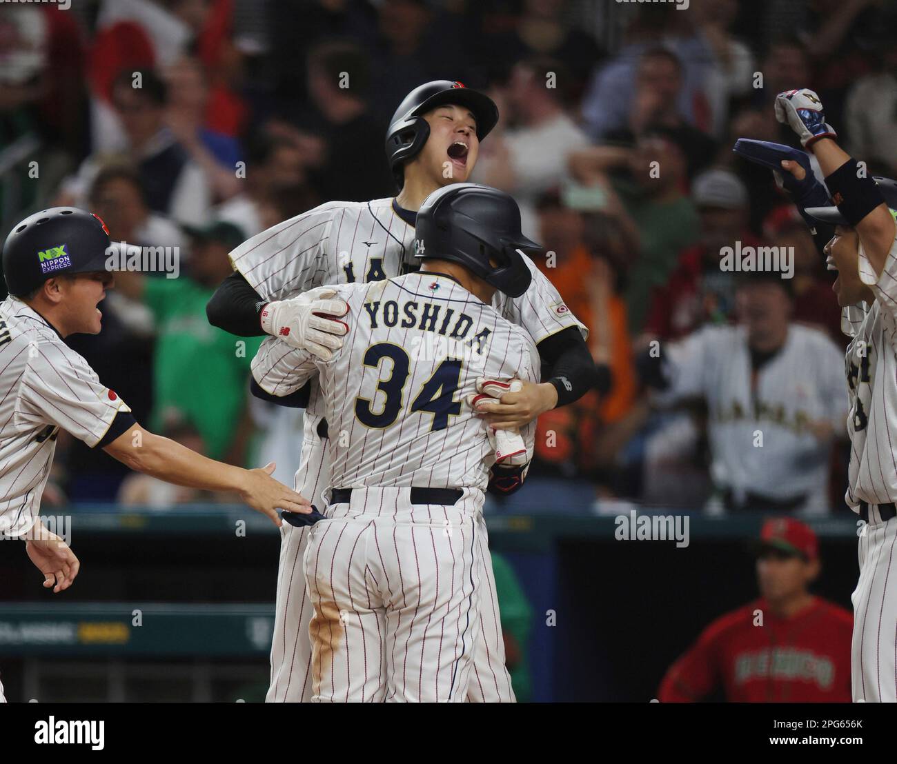 Masataka Yoshida of Japan (34) hits threerun homer in the 7th inning