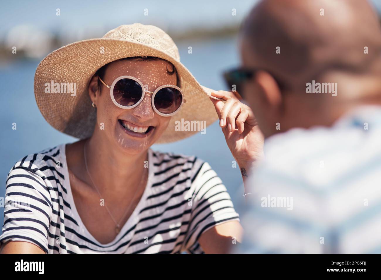 The sun has made me wear this hat today. a cheerful young couple