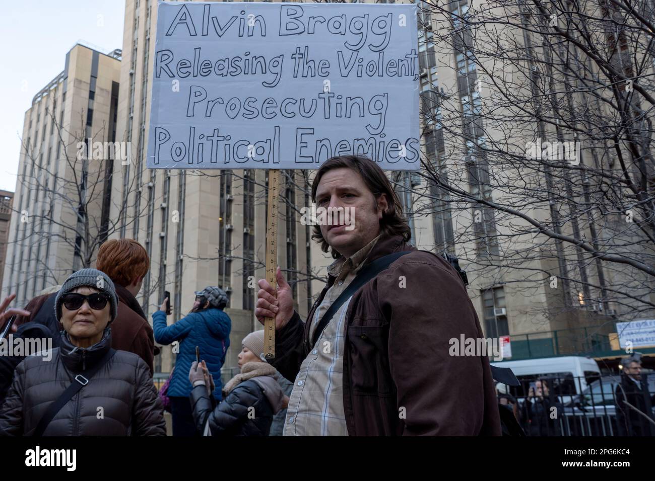 New York, United States. 20th Mar, 2023. A man holds a sign that reads ...
