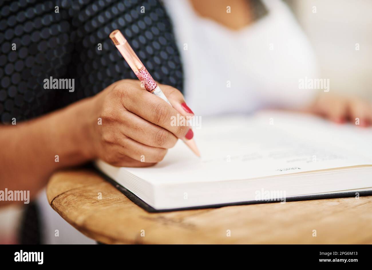 Bake yourself happy. a making notes while wearing a apron Stock Photo