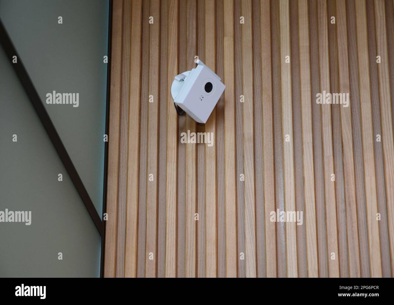 Security  CCTV camera is mounted on the wooden home room wall. CCTV Security Pros: CCTV Security Systems. Stock Photo