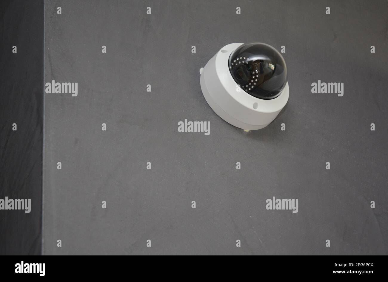 Close up on security  CCTV camera is mounted on the room wall. Stock Photo
