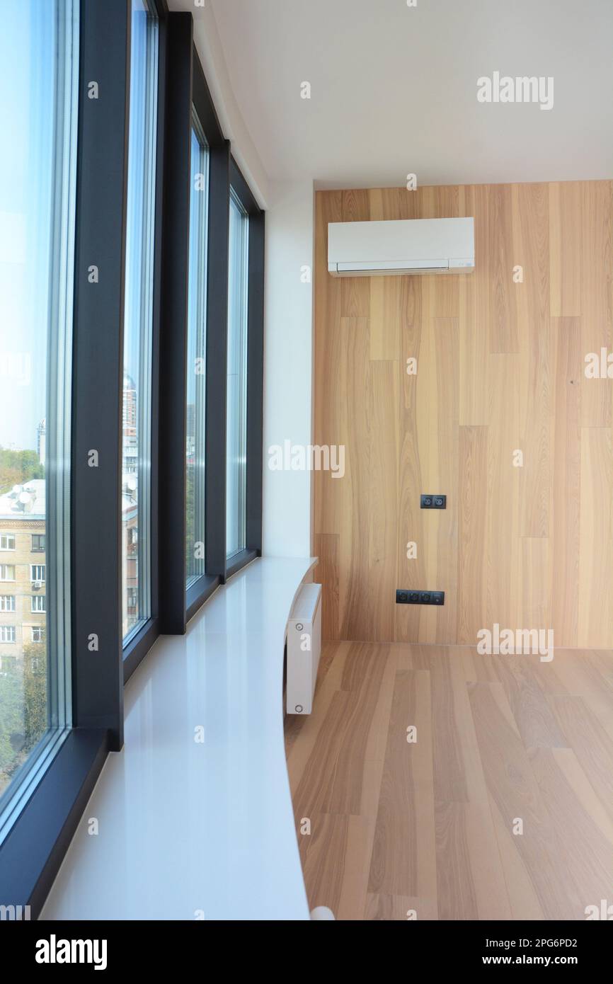 House window sill with radiator heating and wall mounted air conditioner. Stock Photo